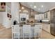 Updated kitchen with white cabinets, granite countertops, stainless steel appliances and adjacent breakfast bar at 4542 Amber Canyon Ln, Las Vegas, NV 89129