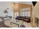 Bright living room boasts vaulted ceilings, tile flooring, a fireplace, and modern furniture at 4542 Amber Canyon Ln, Las Vegas, NV 89129