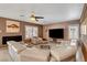 Inviting living room with a fireplace, sectional sofa, and large windows for natural light at 4542 Amber Canyon Ln, Las Vegas, NV 89129