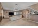 Spacious living room featuring a large sectional sofa, tile floors, and neutral decor at 4542 Amber Canyon Ln, Las Vegas, NV 89129