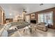 Spacious living room with a fireplace, neutral furnishings, and view of the pool at 4542 Amber Canyon Ln, Las Vegas, NV 89129
