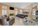 Open-concept living room with vaulted ceilings, a fireplace, and tiled floors at 4542 Amber Canyon Ln, Las Vegas, NV 89129