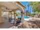 Inviting outdoor patio with outdoor seating and a pristine pool at 4542 Amber Canyon Ln, Las Vegas, NV 89129