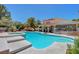 Beautiful backyard oasis with a swimming pool, spa, covered patio, and well-manicured landscaping at 4542 Amber Canyon Ln, Las Vegas, NV 89129