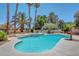 Backyard pool with a spa, several palm trees, and plenty of room for outdoor relaxation at 4542 Amber Canyon Ln, Las Vegas, NV 89129