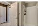 Bright bathroom with white-tiled shower, white door, and neutral-colored walls at 4542 Amber Canyon Ln, Las Vegas, NV 89129