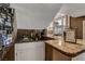 Stylish wet bar with granite countertop, mirrored shelving, and ample storage at 4542 Amber Canyon Ln, Las Vegas, NV 89129