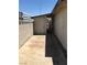 Narrow concrete walkway between the house and cinder block fence leads to a shed at 462 Crestway Rd, Henderson, NV 89015