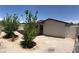 A pair of trees add shade to the gravel-covered backyard with a covered patio at 462 Crestway Rd, Henderson, NV 89015