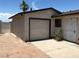 Exterior view of the detached one-car garage with adjacent pedestrian gate at 462 Crestway Rd, Henderson, NV 89015