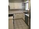 Bright kitchen with white cabinets, stainless steel appliances, and tile flooring at 462 Crestway Rd, Henderson, NV 89015