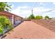 Large, gravel backyard with a sturdy brick wall for privacy, well maintained at 4656 E Desert Inn Rd, Las Vegas, NV 89121
