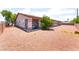 Extensive gravel backyard with a covered patio and secure dog run at 4656 E Desert Inn Rd, Las Vegas, NV 89121
