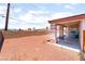 Spacious backyard with a covered patio and low-maintenance gravel landscaping at 4656 E Desert Inn Rd, Las Vegas, NV 89121