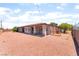 View of large gravel backyard and covered patio extending along the house at 4656 E Desert Inn Rd, Las Vegas, NV 89121