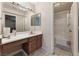 Bathroom showcasing vanity, mirror, good lighting, and a separate water closet with shower and tub at 4656 E Desert Inn Rd, Las Vegas, NV 89121