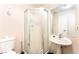 Compact bathroom featuring a pedestal sink and a glass-enclosed shower stall at 4656 E Desert Inn Rd, Las Vegas, NV 89121