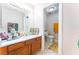 A well-lit bathroom with a sink, vanity, and a separate toilet room for added privacy at 4656 E Desert Inn Rd, Las Vegas, NV 89121