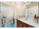 Bathroom featuring a large mirror, single vanity, and toilet at 4656 E Desert Inn Rd, Las Vegas, NV 89121