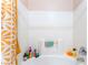 A clean and functional bathtub and shower combination with tiled walls and storage niche at 4656 E Desert Inn Rd, Las Vegas, NV 89121