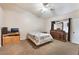 Bedroom showcasing a comfortable bed, ceiling fan, a dresser with mirror, and carpeted floors at 4656 E Desert Inn Rd, Las Vegas, NV 89121