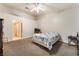 Spacious bedroom featuring neutral walls, ceiling fan, and adjacent bathroom access at 4656 E Desert Inn Rd, Las Vegas, NV 89121