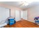 A clean bedroom with wood-look flooring, closet, and a ceiling fan to keep cool at 4656 E Desert Inn Rd, Las Vegas, NV 89121