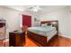 Bedroom features wood floor, ceiling fan, and window with curtains at 4656 E Desert Inn Rd, Las Vegas, NV 89121