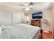 Bedroom featuring ceiling fan, wood floors, closet, and television at 4656 E Desert Inn Rd, Las Vegas, NV 89121