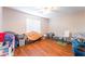 Bedroom filled with storage and personal items featuring wood-look floors and a ceiling fan at 4656 E Desert Inn Rd, Las Vegas, NV 89121