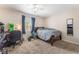 Bedroom with a ceiling fan, carpet, and a window providing natural light at 4656 E Desert Inn Rd, Las Vegas, NV 89121