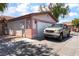 Home exterior showcases a two-car garage and desert-friendly landscaping at 4656 E Desert Inn Rd, Las Vegas, NV 89121