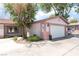 Home exterior showing garage, front lawn and mature trees at 4656 E Desert Inn Rd, Las Vegas, NV 89121
