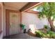 Welcoming front porch with a secure metal screen door, a tree and desert landscaping at 4656 E Desert Inn Rd, Las Vegas, NV 89121