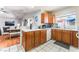 Open kitchen layout with wood cabinets, a dining area and tile flooring at 4656 E Desert Inn Rd, Las Vegas, NV 89121