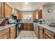 Kitchen features light countertops, wood cabinets, stainless steel appliances, and tiled floor at 4656 E Desert Inn Rd, Las Vegas, NV 89121