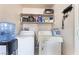 Convenient laundry area with washer, dryer, and shelving for storage at 4656 E Desert Inn Rd, Las Vegas, NV 89121