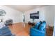 Inviting living room with wood floors, a large television, and comfortable blue seating at 4656 E Desert Inn Rd, Las Vegas, NV 89121