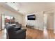 Cozy living room featuring sliding glass doors to the backyard and a mounted TV at 4656 E Desert Inn Rd, Las Vegas, NV 89121
