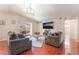 Spacious living room features hardwood floors, ample seating, and a sliding glass door at 4656 E Desert Inn Rd, Las Vegas, NV 89121