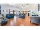 Spacious living room with wood floors, vaulted ceiling, multiple seating options and backyard access at 4656 E Desert Inn Rd, Las Vegas, NV 89121