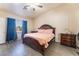 Bright main bedroom with wood-look flooring, decorative bedside tables and accents, plus a ceiling fan at 4656 E Desert Inn Rd, Las Vegas, NV 89121