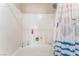Shower-tub combination with white tile surround and a shower curtain with a sea theme at 4656 E Desert Inn Rd, Las Vegas, NV 89121