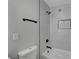Modern bathroom features matte black fixtures, gray walls and tub with tiled shelf at 4807 Sacks Dr, Las Vegas, NV 89122