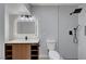 Modern bathroom with dark fixtures, a white toilet, and unique lighting at 4807 Sacks Dr, Las Vegas, NV 89122