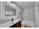 Clean bathroom featuring wood cabinets, modern fixtures, and a shower/tub combo at 4807 Sacks Dr, Las Vegas, NV 89122
