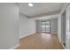 Bright, empty bedroom showcasing modern flooring, fresh paint, and a sliding glass door that fills the space with natural light at 4807 Sacks Dr, Las Vegas, NV 89122