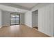 Bedroom featuring a closet, light wood floors, and a sliding glass door to the balcony at 4807 Sacks Dr, Las Vegas, NV 89122