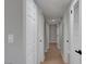 Bright hallway with neutral paint, wood-look flooring, and crisp white doors creating a clean and welcoming ambiance at 4807 Sacks Dr, Las Vegas, NV 89122