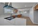 Modern kitchen with white countertops and wood cabinets opens to dining and living areas at 4807 Sacks Dr, Las Vegas, NV 89122